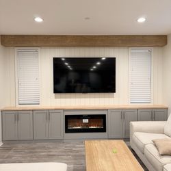 Legacy Cabinets - Built in cabinets with header, fireplace and shiplap accent wall
