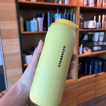 Starbucks - a hand holding a yellow cup - Coffee & Tea Near Me - Riverside, California Starbucks - a hand holding a yellow cup - Coffee & Tea Near Me - Riverside, California