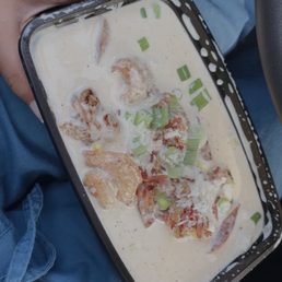a person holding a tray of food a person holding a tray of food