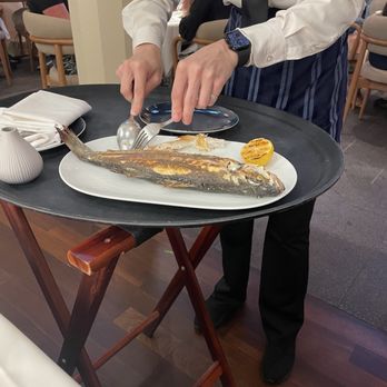 Naōs Hellenic Cuisine - Whole Branzino being deboned tableside - Wine Bars Near Me - Cary, North Carolina Naōs Hellenic Cuisine - Whole Branzino being deboned tableside - Wine Bars Near Me - Cary, North Carolina