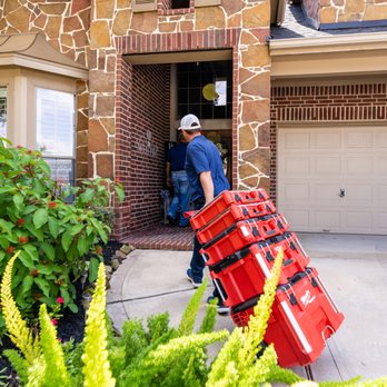 Cinco Ranch Plumbing - a man carrying a red fire hydrant - Plumbing Near Me