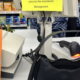 a black purse and a yellow sign