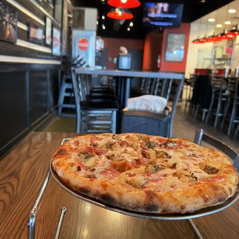 Little India Pizza® - a pizza on a metal tray - Pizza Near Me - Frisco, Texas Little India Pizza® - a pizza on a metal tray - Pizza Near Me - Frisco, Texas