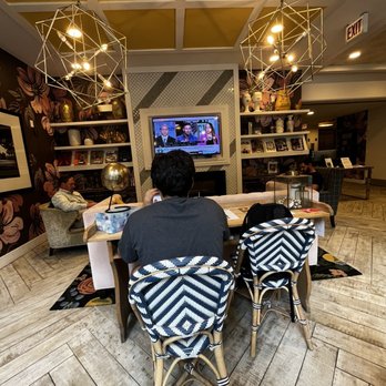 Dollop Coffee - a person sitting at a table in a coffeehouse - Cafes Near Me - Chicago, Illinois