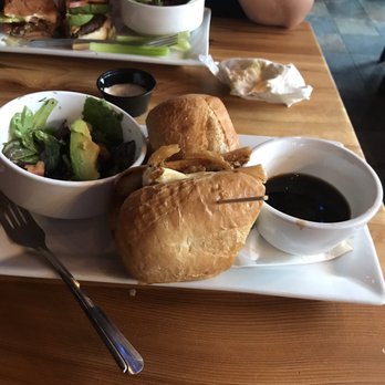 Thomas Street Warehouse - Background is a burger, foreground is French dip with cheese curds and a salad. - Bars Near Me - Seattle, Washington
