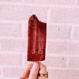 a hand holding a popsicle