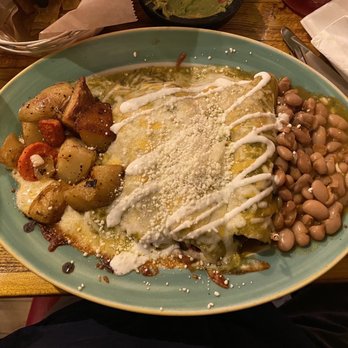 Alebrijes Kitchen - Beef enchilada with green sauce. Served with pinto beans and potatoes. - Mexican Near Me - Seattle, Washington