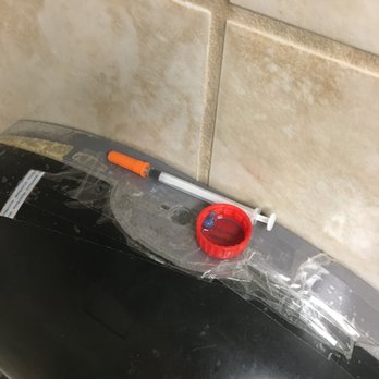 Kroger - needle and bottle cap (unknown substance) sitting on top of the empty and taped together toilet paper dispenser - Grocery Near Me - Hermitage, Tennessee