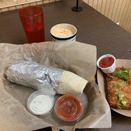 Breakfast burrito, hash-brown, and cappuccino Breakfast burrito, hash-brown, and cappuccino