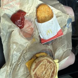 McDonald's - Sausage McGriddle with Sausage, Egg and Cheese McGriddles® Meal with a hash brown.