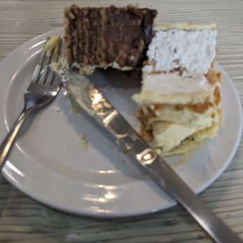 Cafe Balkan - A half piece of a German chocolate cake and some kind of creamy pastry - Modern European Near Me - Phoenix, Arizona