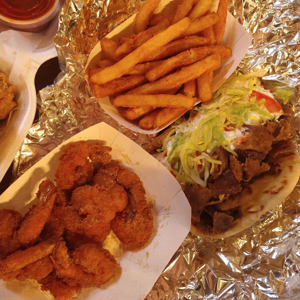 Louie Legends - a variety of food items on a table - Chicken Wings Near Me - Peoria, Illinois