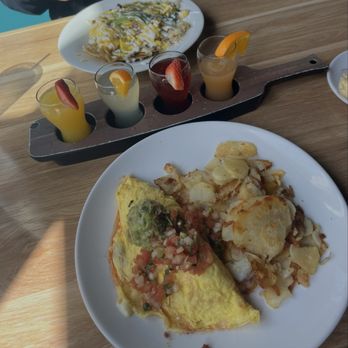 Broken Yolk Cafe - Chilaquiles Bowl, Mimosa Flight, El Fuego omelet with home fries. - Breakfast & Brunch Near Me - Costa Mesa, California Broken Yolk Cafe - Chilaquiles Bowl, Mimosa Flight, El Fuego omelet with home fries. - Breakfast & Brunch Near Me - Costa Mesa, California
