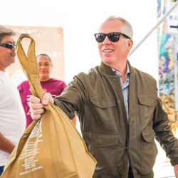 Thomas J. Henry Law - Turkey Giveaway 2019 - Thomas J. Henry handing out a turkey bag