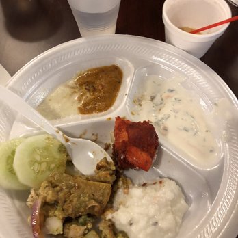 Madras Cafe - a plate of food with a variety of sauces - Indian Near Me - Niagara Falls, New York Madras Cafe - a plate of food with a variety of sauces - Indian Near Me - Niagara Falls, New York