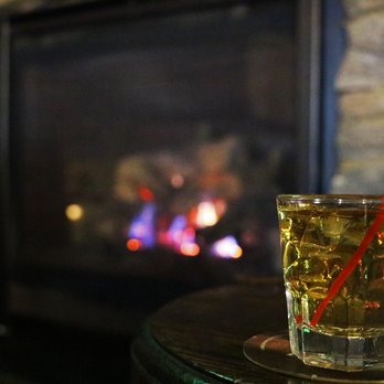 Daly's Pub - a drink on a table in front of a fireplace - Pubs Near Me - Astoria, New York Daly's Pub - a drink on a table in front of a fireplace - Pubs Near Me - Astoria, New York