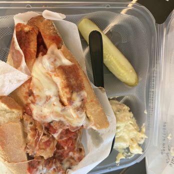 Carmines - a sandwich and a pickle on a tray - Bakeries Near Me - Palm Beach Gardens, Florida Carmines - a sandwich and a pickle on a tray - Bakeries Near Me - Palm Beach Gardens, Florida