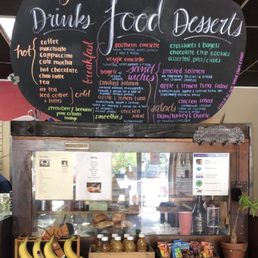 Front counter with a display of pastries & menu.