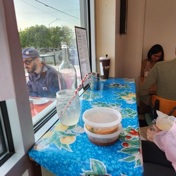 Funky Elephant - Our "table" right beside the window while we eat. Reminiscent of street food eateries in Asia, including the humble vinyl table cover! :) - Thai Near Me - Berkeley, California