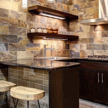 The Tile Shop - a kitchen with a counter and stools - Flooring Near Me - Orlando, Florida The Tile Shop - a kitchen with a counter and stools - Flooring Near Me - Orlando, Florida
