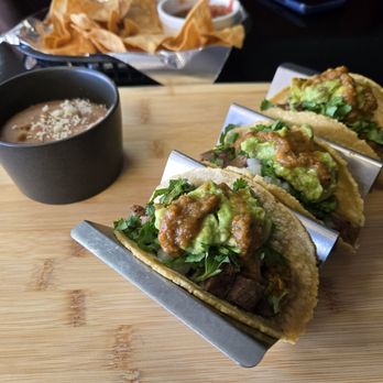 Sazzon Baja Mex Culinary - Carne asada tacos served with refritos. Chips and salsa bringing up the rear - Seafood Near Me - Alpine, Texas Sazzon Baja Mex Culinary - Carne asada tacos served with refritos. Chips and salsa bringing up the rear - Seafood Near Me - Alpine, Texas