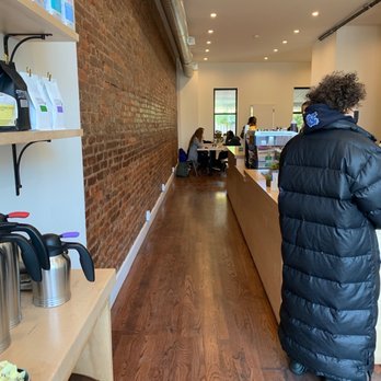 Hamlet Coffee - a woman standing in a coffee shop - Coffee & Tea Near Me - Brooklyn, New York