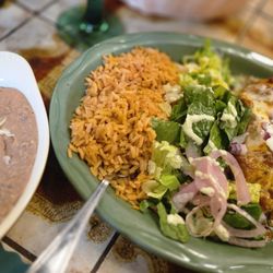 El Rincon Restaurante Mexicano - Side of refried beans and the shredded beef with all rice chimichanga with green sauce