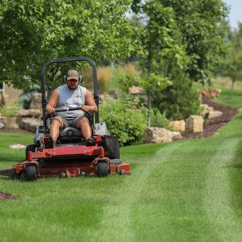 CJ's Lawn and Snow Services - a man mowing the lawn - Lawn Services Near Me CJ's Lawn and Snow Services - a man mowing the lawn - Lawn Services Near Me