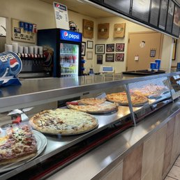 a variety of pizzas on display a variety of pizzas on display