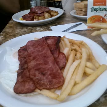 Apollon Restaurant - Two fried eggs over easy with french fries and turkey bacon. - American Near Me - Yonkers, New York
