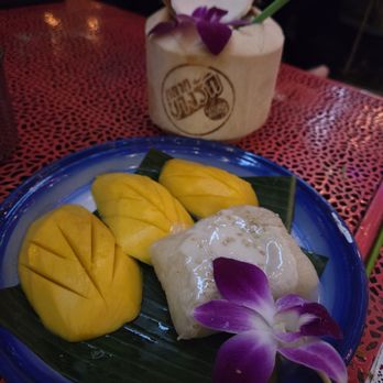 Bangrak Market - One of the deserts in the menu. Enjoying sipping some coconut juice from a coconut - Bars Near Me - Seattle, Washington