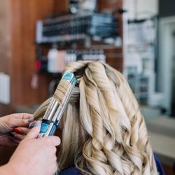 Amber Salon - Use a flatiron to curl her hair
