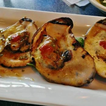 Riverwalk Restaurant - Char-Grilled Oysters.. $14  on the Half Shell , Sriracha Lime Butter, Candied Basil. Locally harvested - New American Near Me - Yorktown, Virginia