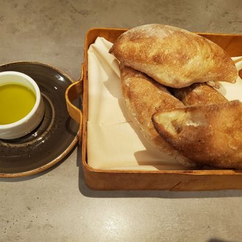 Clarity - French bread and sunflower bread served with truffle oil - New American Near Me - Vienna, Virginia Clarity - French bread and sunflower bread served with truffle oil - New American Near Me - Vienna, Virginia
