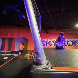 Sky Zone Trampoline Park - Broken fence on the raised platform kids jump off of.