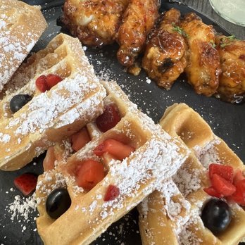 Dubs Brunch Bar - Air "FRIED" chicken wings tossed in a sweet Thai Chili sauce with a fluffy waffle with powdered sugar and berries - Seafood Near Me - Hollywood, Florida Dubs Brunch Bar - Air "FRIED" chicken wings tossed in a sweet Thai Chili sauce with a fluffy waffle with powdered sugar and berries - Seafood Near Me - Hollywood, Florida