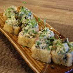 Miku Asian Kitchen & Bar - Yellowtail Ceviche Roll: Kani, Avocado, Yellowtail deep fried. Topped with Yellowtail ceviche mix, fried capers, and micro greens.