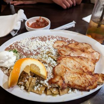 Los Compadres - Green chilaquiles breakfast plate with delicious chicken fillet - Mexican Near Me - Long Beach, California