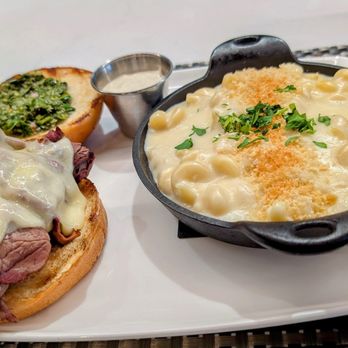 Sierra Grill - Prime Rib sandwich- Smoked sliced prime rib, Swiss cheese, horseradish sauce, Brioche bun, béchamel macaroni and cheese. - Steakhouses Near Me - Lenexa, Kansas Sierra Grill - Prime Rib sandwich- Smoked sliced prime rib, Swiss cheese, horseradish sauce, Brioche bun, béchamel macaroni and cheese. - Steakhouses Near Me - Lenexa, Kansas