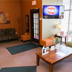 Smile Studio 87 - Relax in our reception area featuring comfortable couches, natural lighting, and soothing music.