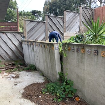 Sione's Concrete Construction - BEFORE. Concrete retaining wall had failed. Back yard was unusable, no space for a table. - Landscaping Near Me - San Carlos, California