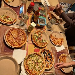 a table full of pizzas a table full of pizzas