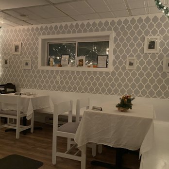 The Bavaria Restaurant - a dining room with white tables and white chairs - German Near Me - Sidney, New York