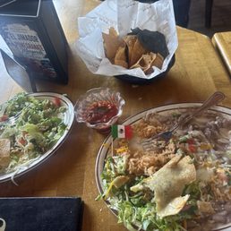Left: Half order of tostada Middle: chips and salsa Right: one time combination plate crispy shredded beef taco with rice and beans Left: Half order of tostada Middle: chips and salsa Right: one time combination plate crispy shredded beef taco with rice and beans