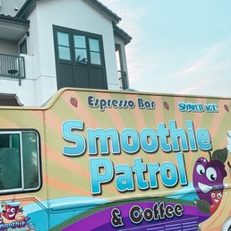a smoothie truck parked in front of a building a smoothie truck parked in front of a building