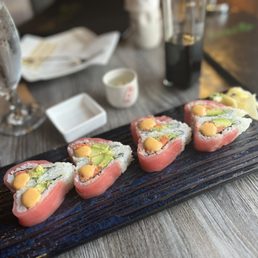 a plate of sushi rolls on a table a plate of sushi rolls on a table
