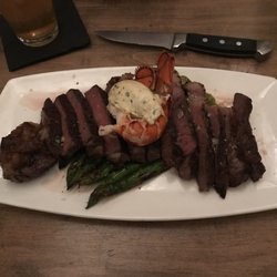 Bighorn Steakhouse - My Valentine's Day meal for 2, for 1. 20oz Ribeye, petite lobster tail on Asparagus.