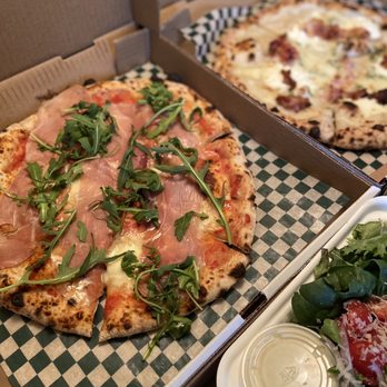 Vera - two pizzas and a salad on a table - Pizza Near Me - Winnipeg, Manitoba Vera - two pizzas and a salad on a table - Pizza Near Me - Winnipeg, Manitoba