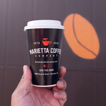 Marietta Coffee Company - a hand holding a cup of coffee - Coffee & Tea Near Me - Marietta, Georgia