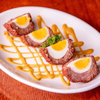 The Pub - Naples - delicately boiled egg wrapped in sausage & parmesan breadcrumbs, served with spicy pub mustard - British Near Me - Naples, Florida